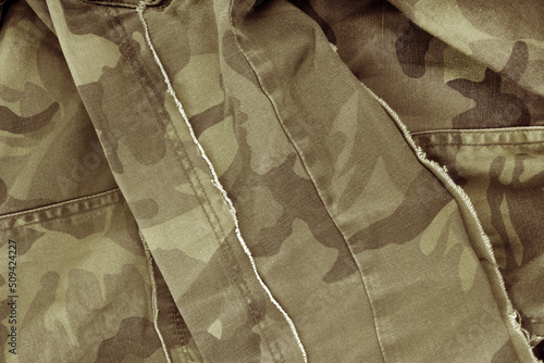 close up of the camouflage textured fabric wavy background photo