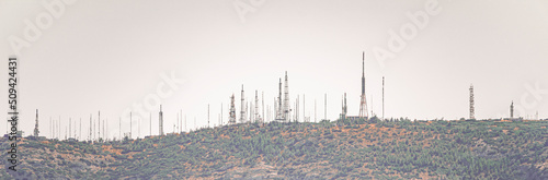 Panoramic of a mountain full of radio frequency and television antennas