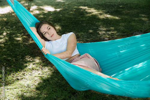 Slow life. Enjoying the little things. spends time in nature in summer. a a woman rests in a hammock the garden on a summer day