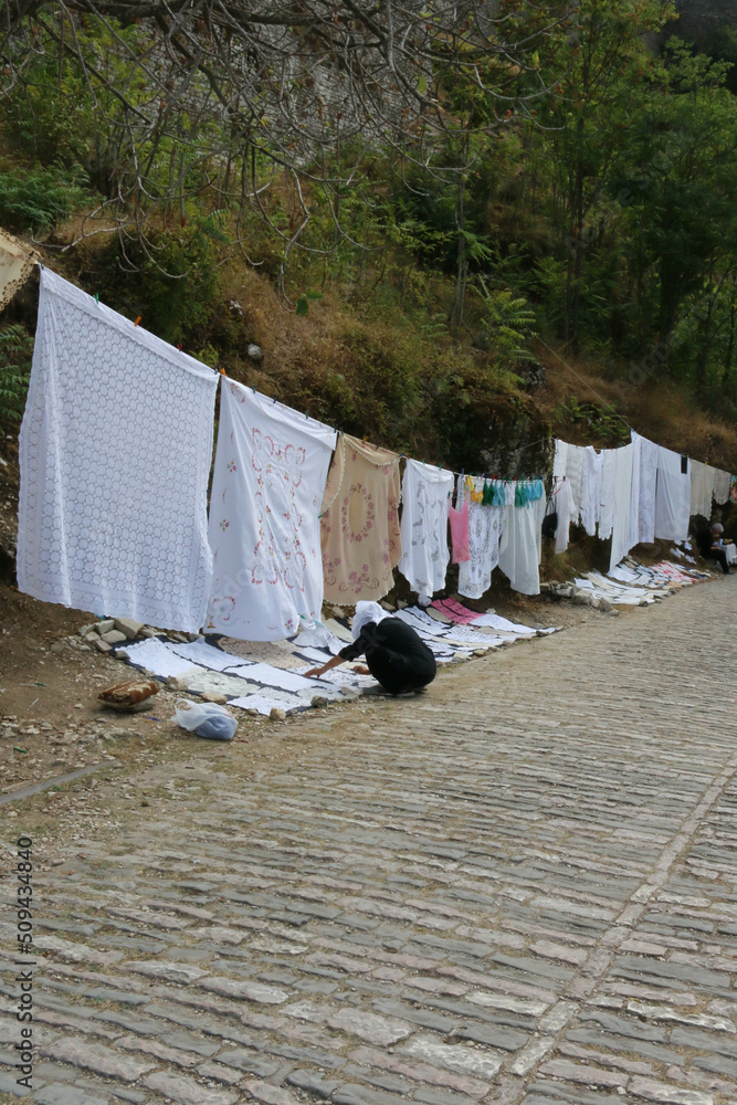typical street sale of textiles in the streets of Gjirokaster, Albania