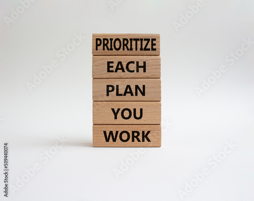 Priority, plan and work symbol. Wooden blocks with words Prioritize each plan you work. Beautiful white background. Business and Prioritize each plan you work concept. Copy space