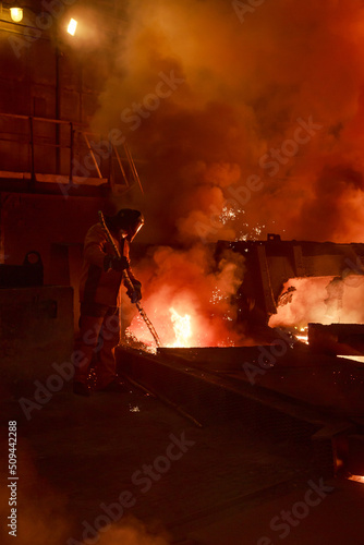 Steel foundry worker at blast furnace workshop.