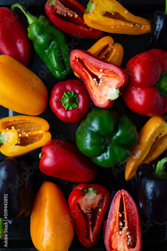 Fotografiet Overhead view of ripe red yellow green bell pepper food background whole and sli