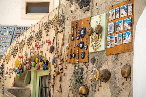 Fototapeta Naklejka Na Ścianę i Meble -  Gifts of colors typical of Santorini in Greece, bells, cats, and pendants