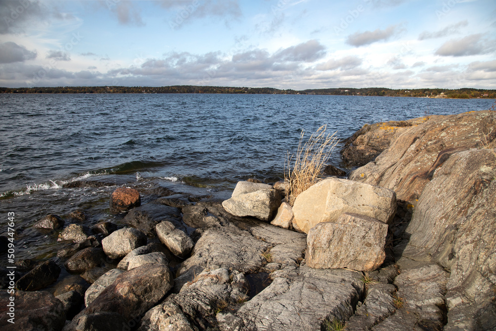 Rocky seashore under blue cloudy sky Rocky seashore under blue cloudy sky
