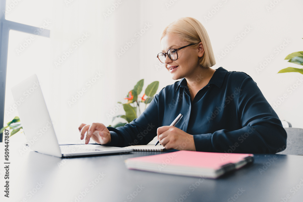 Online studies, remote work on laptop, e-learning concept. Caucasian young smart businesswoman ceo boss teacher tutor student learning languages online, taking notes, doing homework for university Online studies, remote work on laptop, e-learning concept. Caucasian young smart businesswoman ceo boss teacher tutor student learning languages online, taking notes, doing homework for university