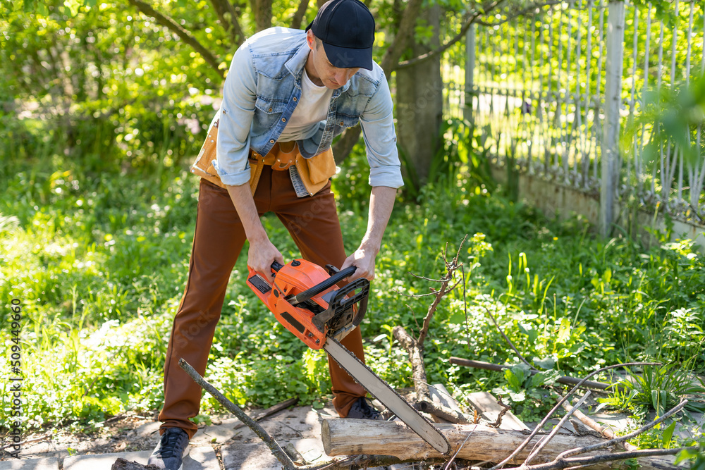 man sawing branches with a chainsaw. Concept of a professional logging man sawing branches with a chainsaw. Concept of a professional logging