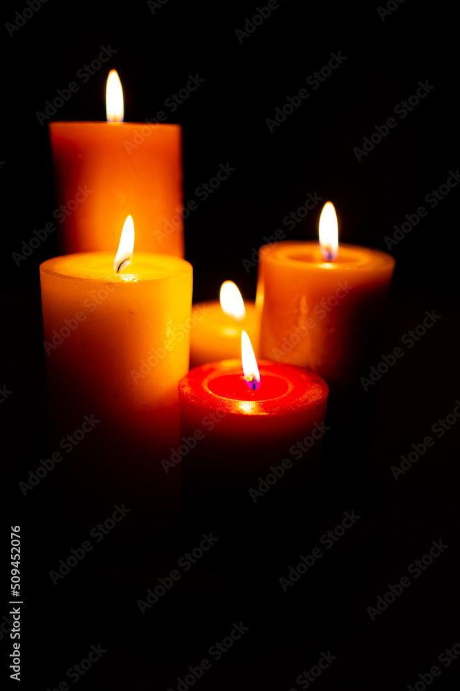 Burning red candles on black background Burning red candles on black background