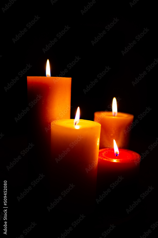 Burning red candles on black background Burning red candles on black background