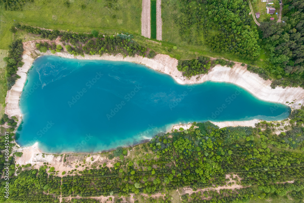 ariel top view of an old flooded lime quarry with turquoise water
