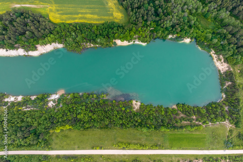 ariel top view of an old flooded lime quarry with turquoise water