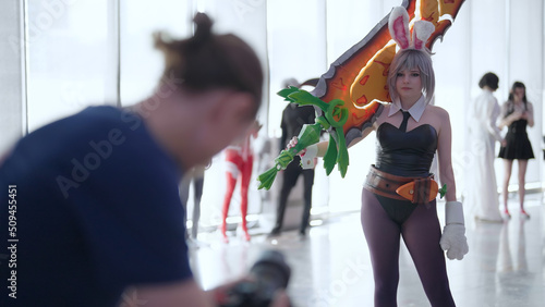 Videographer shooting Battle Bunny Riven cosplay girl on comic con