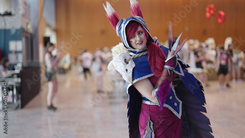 Comic con cosplay character Xayah from League of Legends game pose photo