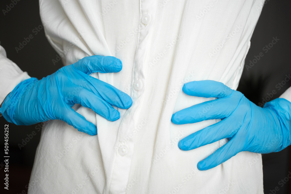 Blue medical gloves at the waist Blue medical gloves at the waist