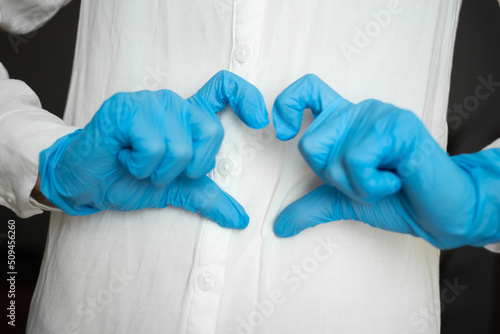 Hands in median gloves show heart