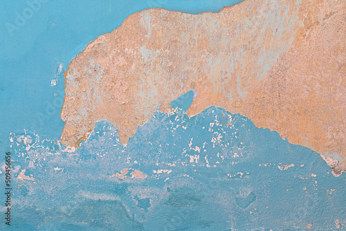 Fototapeta Naklejka Na Ścianę i Meble -  Close up of blue plaster peeling off due to humidity.