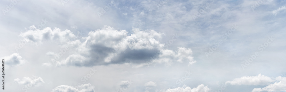 Obraz premium Big white curly clouds in the gray-blue sky in soft pastel colors