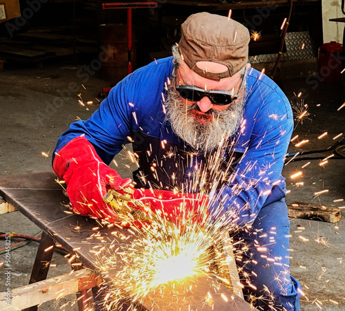 Welder worker with flame torch cutter