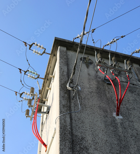voltage electrical cables in the substation with insulators and powerlines photo