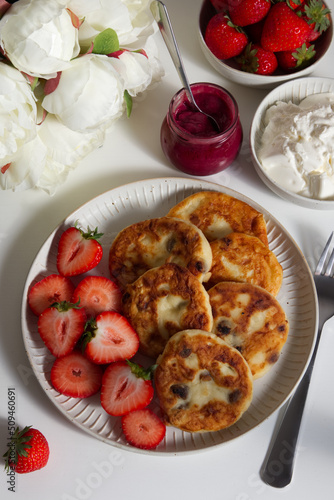 Wallpaper Mural cottage cheese pancakes with strawberries and a bowl of berries, jam, sour cream and peonies Torontodigital.ca
