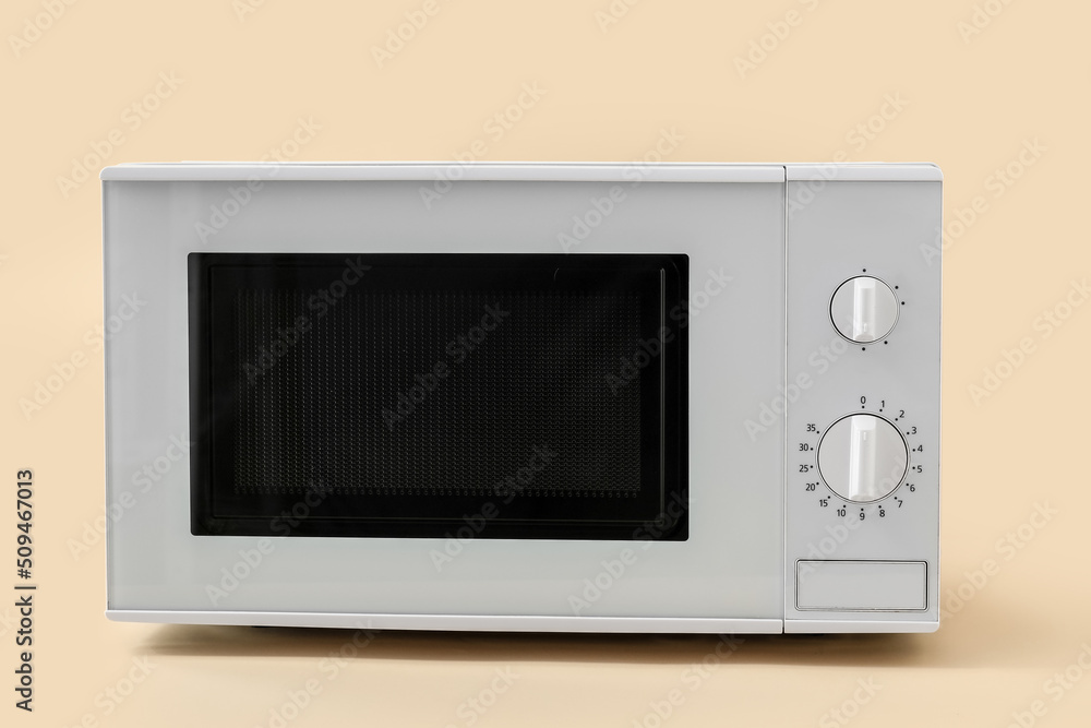 New modern microwave oven on color background New modern microwave oven on color background