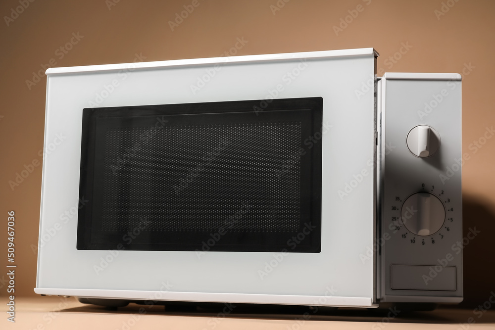 New modern microwave oven on color background New modern microwave oven on color background