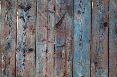Old blue wooden surface with peeling paint.