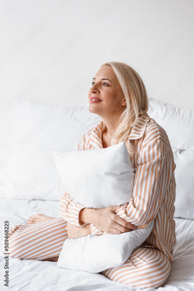 Morning of beautiful mature woman in bedroom Morning of beautiful mature woman in bedroom