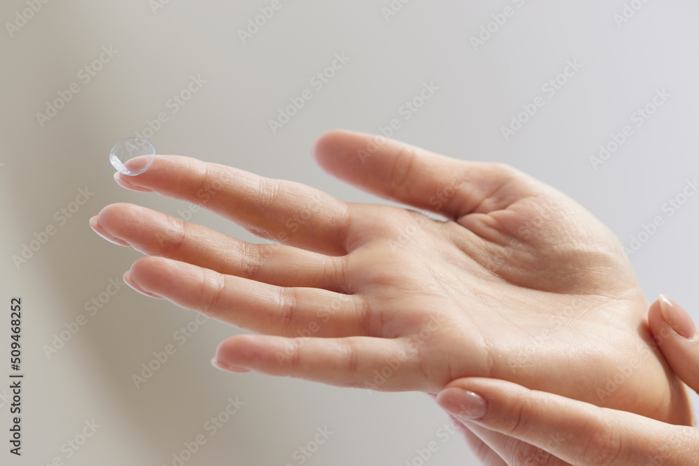 Contact Eye Lenses. Woman Hands Holding Contact Eye Lens. Closeup Of Girl Hand With Transparent Eye lens On Her Finger. High Resolution Image Contact Eye Lenses. Woman Hands Holding Contact Eye Lens. Closeup Of Girl Hand With Transparent Eye lens On Her Finger. High Resolution Image