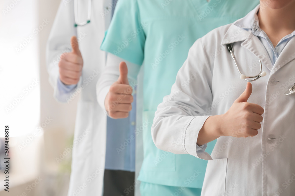 Group of doctors showing thumb-up in clinic Group of doctors showing thumb-up in clinic