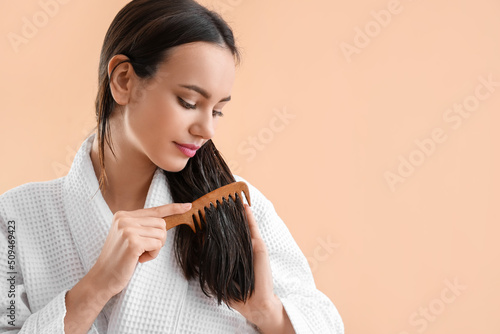 Young woman brushing her ha...