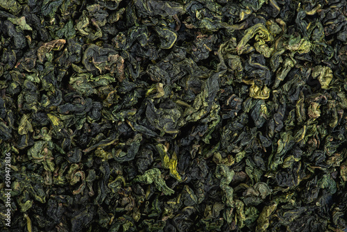 Chinese green leaf oolong tea. Dried tea leaves background, top
