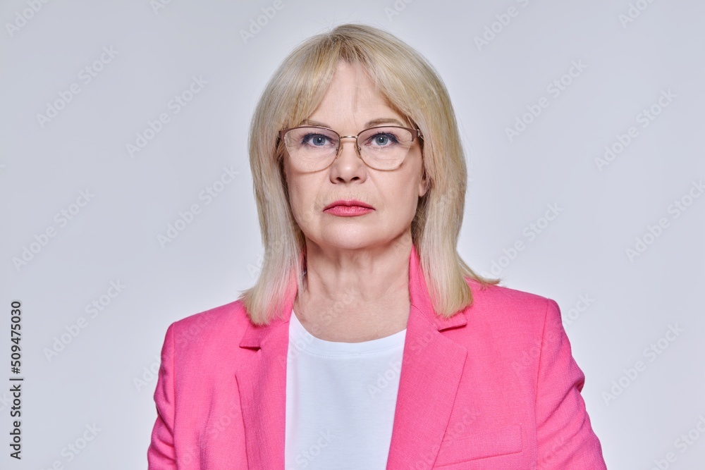 Portrait of senior business successful woman in glasses looking at camera