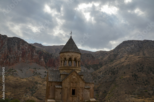 Holy Mother of God church (Surb Astvatsatsin) of the Noravank Monastery Complex against the sheer red rocks. Armenia 