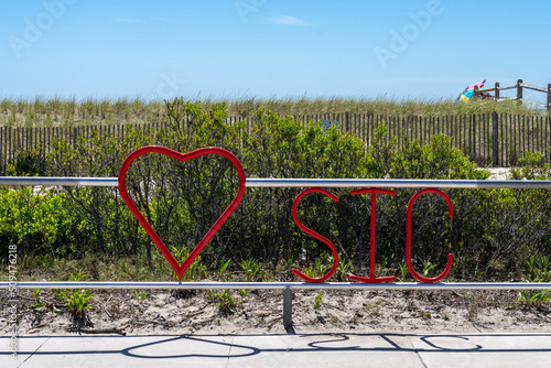 Heart SIC railing in Sea Isle City, New Jersey with beach dune and fencing behind