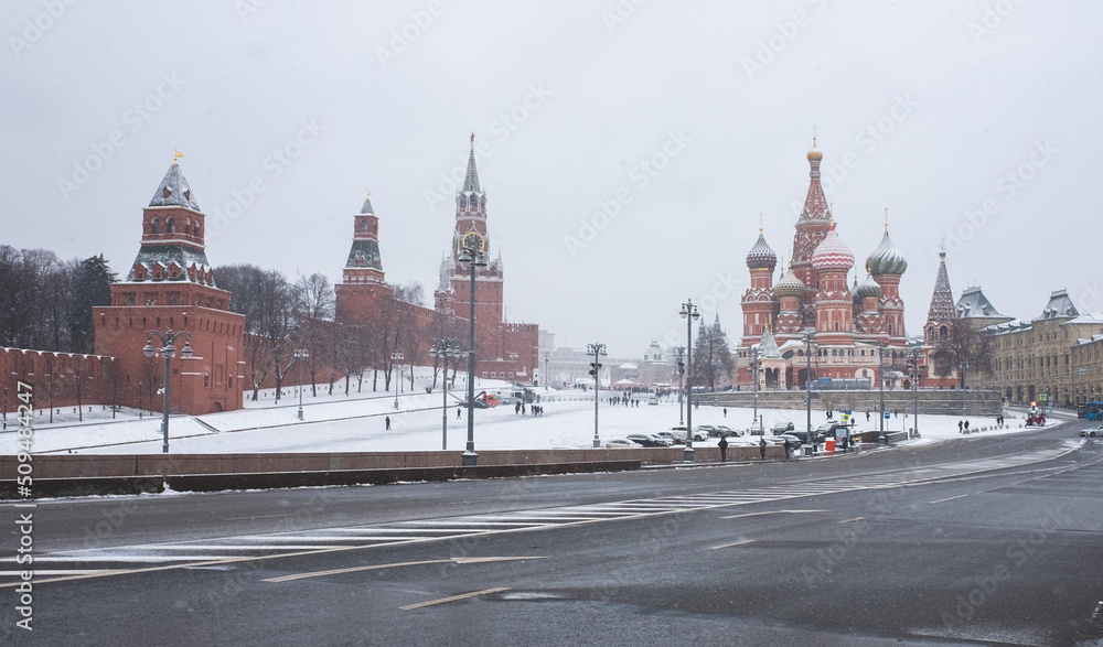Fototapeta premium View of Vasilyevsky Spusk, the Moscow Kremlin and St. Basil's Cathedral in winter during a snowfall.
