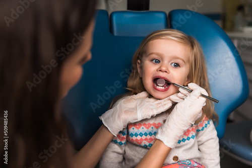 examination, treatment teeth children. medical checkup oral cavity with instruments. dental hands, child in clinic. Cute girl smiling stomatology. Happy kid in dentist chair. concept health, medicine