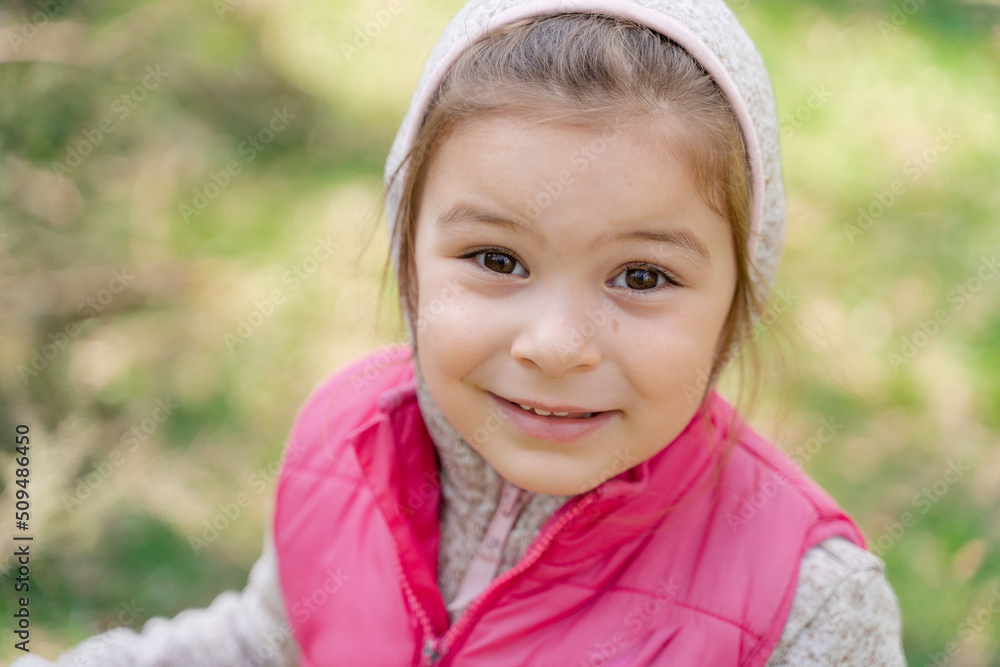 Close up portrait of preschool girl outdoors on a sunny spring or fall day Close up portrait of preschool girl outdoors on a sunny spring or fall day
