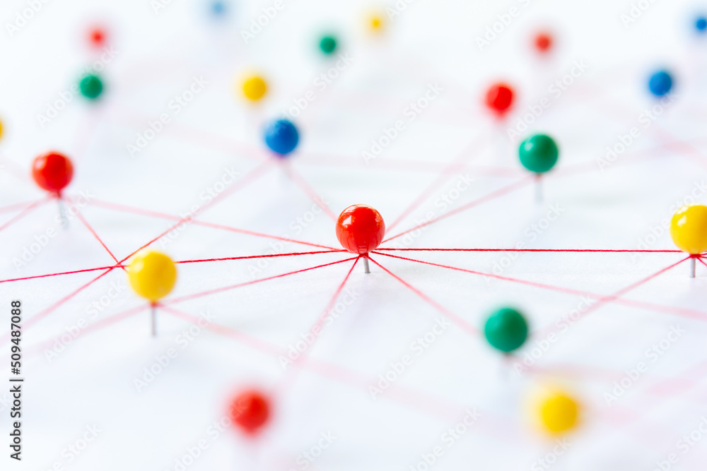 Linking entities, Blockchain, social media, Communications Network, The connection between the two networks. Network simulation on paper linked together by yarn Linking entities, Blockchain, social media, Communications Network, The connection between the two networks. Network simulation on paper linked together by yarn