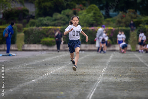 Young girl sprinting in 100-meter race. © Kelly