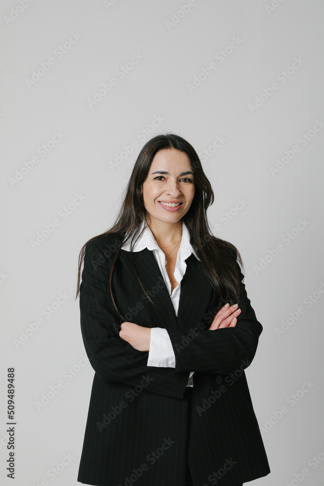Happy middle-aged businesswoman posing on white wall. Vertical. Mock-up. Happy middle-aged businesswoman posing on white wall. Vertical. Mock-up.