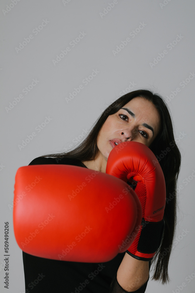 Middle age caucasian woman punching fist to fight, aggressive and angry attack. Middle age caucasian woman punching fist to fight, aggressive and angry attack.