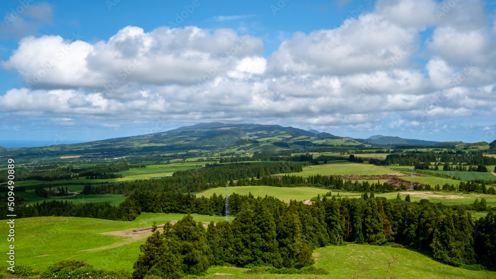Beautiful green landscape on a cloudy blue sky in São Miguel, Azores Islands, Portugal. Nature amazing Green Landscape of Azores.