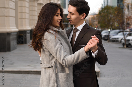 a beautiful young couple walking around the city.man and woman in business style