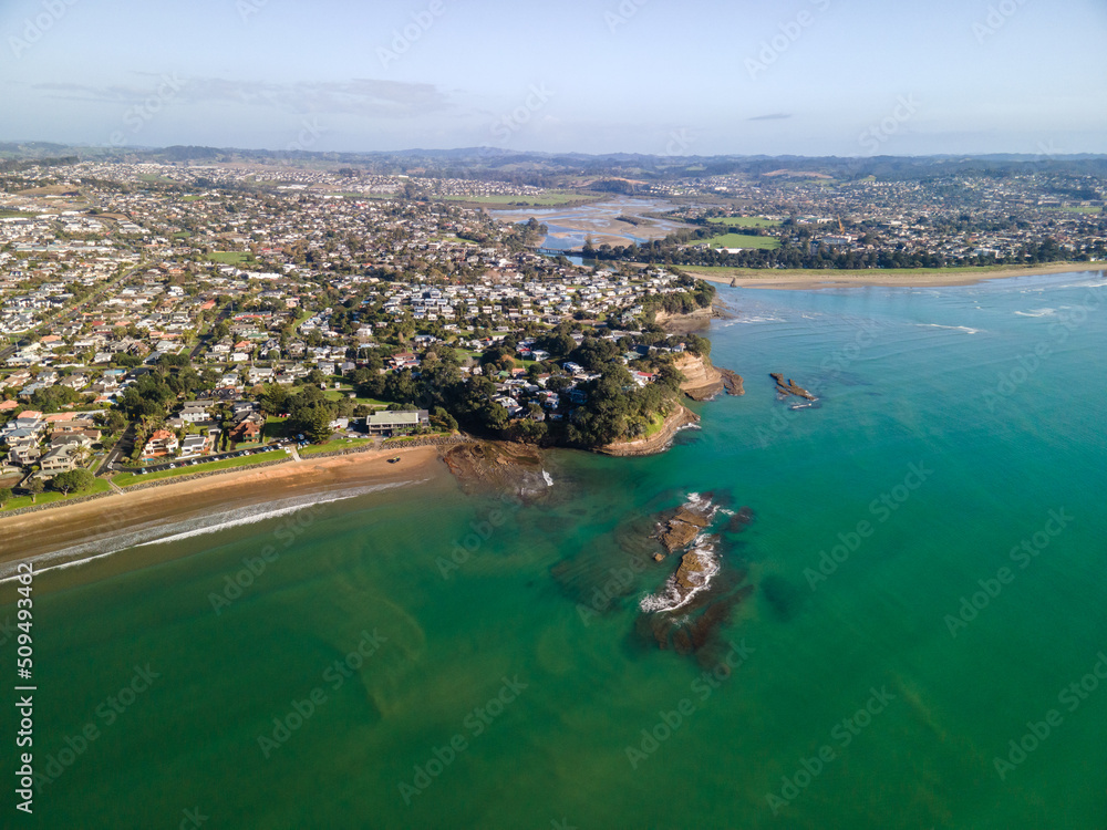 Spectacular beachfront properties seen aerially from the sky by drone in Red beach, New Zealand 