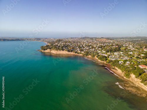 Spectacular beachfront properties seen aerially from the sky by drone in Red beach, New Zealand 
