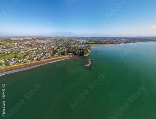 Fototapeta Naklejka Na Ścianę i Meble -  Spectacular beachfront properties seen aerially from the sky by drone in Red beach, New Zealand 