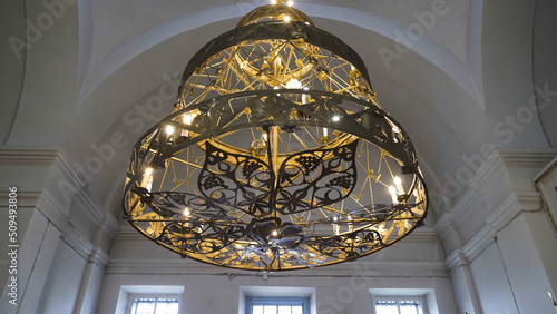 Beautiful gilded chandelier in Church. Stock footage. Panikadilo is main lamp of temple and symbol of Heavenly Church. Openwork patterns Church chandeliers with candles look divine photo