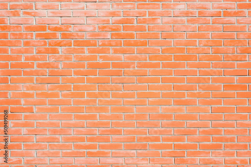 Red brick wall background outside of the building.
