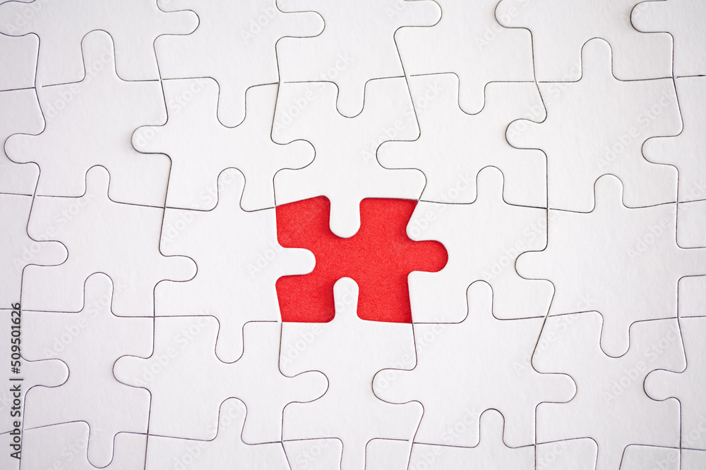 missing piece of jigsaw puzzle with red background missing piece of jigsaw puzzle with red background